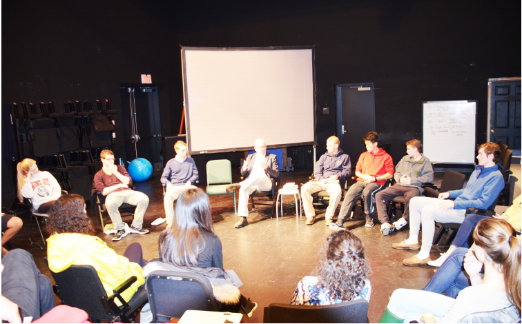 Students+gather+around+Paul+Barrett+to+discuss+U.S.+gun+policy.