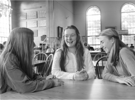Anna Cardy laughs with friends after a meal in the Dining Hall.