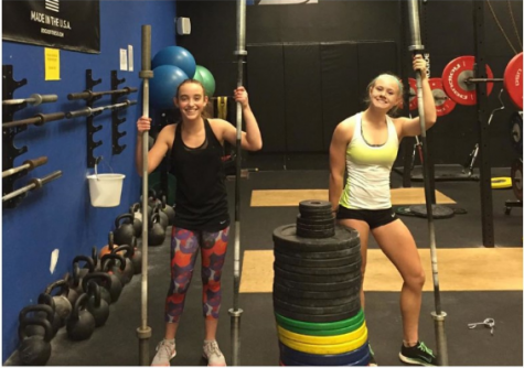 Carrie Moore ‘17, right, pumping iron.