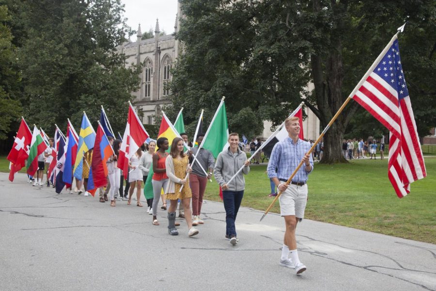 Students carrying flags at Convocation.